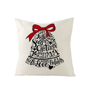 Détail d'une housse de coussin de Noël en lin avec typographie de cloche et nœud
