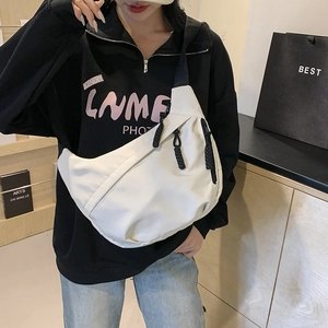 White minimalist nylon crescent crossbody bag with black adjustable shoulder strap