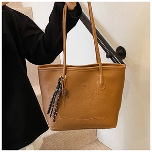 Brown leather tote bag with FASHION print and tennis racket charm detail