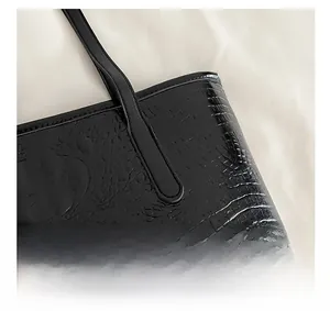 Detailed close-up of premium black crocodile pattern leather tote with quality stitching