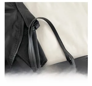Close-up of comfortable flat shoulder straps on black croc-effect leather tote bag