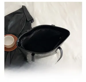 Top view showing large interior capacity and zipper of the black crocodile pattern tote bag
