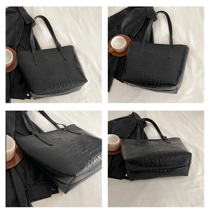 Detail view of black crocodile pattern tote bag showing multiple angles and glossy texture