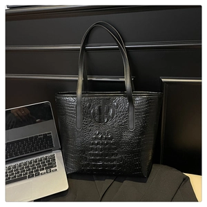 Detail shot of the black crocodile pattern texture on a large capacity tote bag