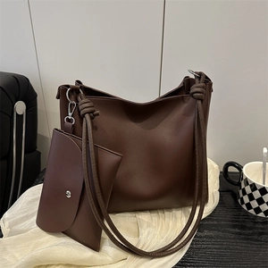 Retro brown large capacity tote bag with matching pouch on soft white textured fabric