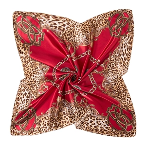 Macro shot of 90x90cm leopard print scarf with red panels and golden chain patterns