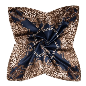 Detailed close-up of a blue leopard and gold chain print square satin silk scarf