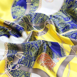 Detailed view of luxury silk scarf with vintage chain patterns and paisley motifs