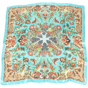 Detail of teal paisley satin square scarf with vintage floral patterns and silk finish