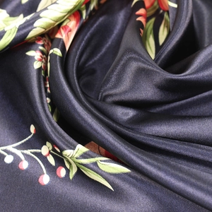 Close-up of luxury silk scarf with floral print and smooth shimmering texture