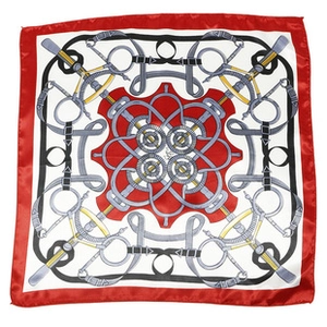 Detailed pattern of the square silk scarf with horse bits and chain prints in vibrant red