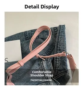 Detail view of pink leather shoulder strap with silver metal ring and neat stitching