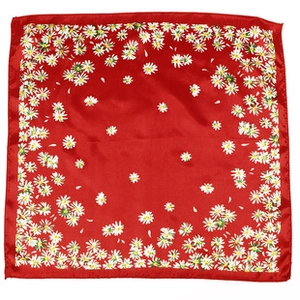 Detail of red satin square scarf featuring white daisy floral pattern and smooth edges