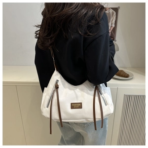 Detail of white nylon tote bag with brown straps and leather Fashion Bags logo plaque