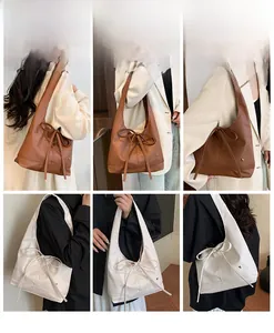 Detail shot of large tote bag featuring elegant side bow tie and soft leather texture