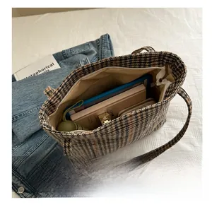 Detailed interior of a plaid tote bag showing large capacity for essentials