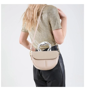 Detail der beige Halbmond-Satteltasche mit gewebter Klappe und silbernem Metallgriff
