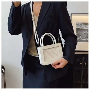 Detail of white minimalist cosmetic bag with transparent window and smooth leather handles