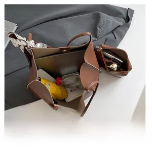 Interior view of brown leather tote showing spacious capacity and matching pouch