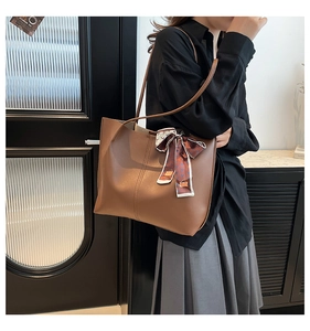 Side view of dark brown tote bag with decorative patterned silk scarf for daily wear