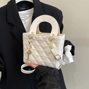 Quilted white crossbody bag with gold hardware and chain charm detail for women