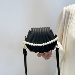 Black shell crossbody bag with pearl handle and vertical embossed texture for women