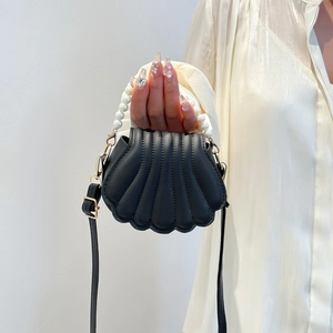 Elegant black shell-shaped handbag with quilted pattern and luxury pearl top handle