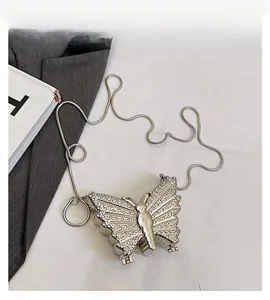 Detail shot of the rhinestone-embellished silver butterfly bag with sleek snake chain