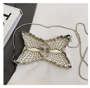 Detail of silver butterfly metal bag showing the internal structure and magnetic closure