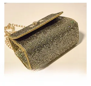 Detail showing the shiny rhinestone surface and golden chain strap of the fashion mini bag