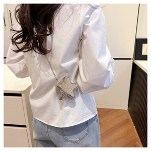 Star-shaped silver crossbody bag with rhinestones shown on a model from behind