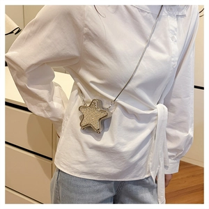 Detail of silver star-shaped crossbody bag with rhinestones and metal chain strap