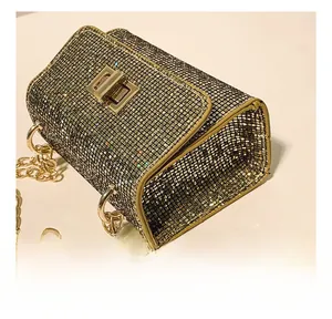 Detail shot of shimmering sequin evening bag showing precision stitching and gold clasp