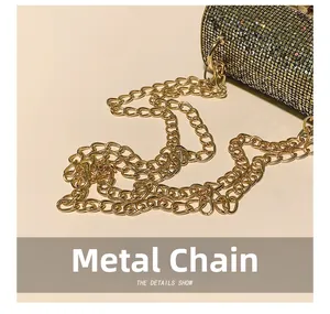 Close-up of elegant gold chain strap and cylindrical rhinestone evening bag details