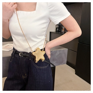 Detailed view of a star-shaped rhinestone mini bag with a delicate gold chain strap