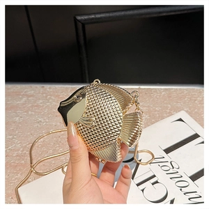 Detailed view of a gold fish-shaped evening bag with scale texture and snake chain