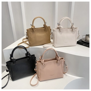 Four leather bucket bags in khaki white black pink with metal ball handle detail