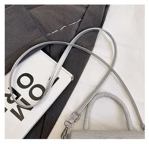 Close-up of silver glitter handbag with durable leather strap and metallic buckle