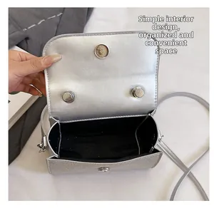 Detailed interior view of silver glitter crossbody bag with magnetic closure and black lining
