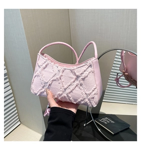 Detail of pink quilted tote bag showing fringe denim texture and vegan leather bottom
