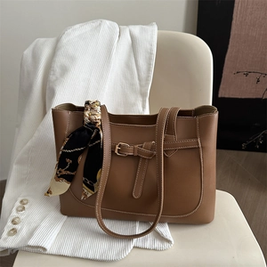 Brown faux leather tote bag with printed silk scarf wrap on handle for daily commuting