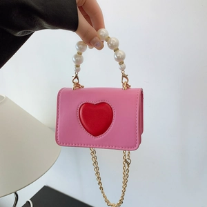 Pink mini crossbody bag with red heart relief, pearl handle and gold chain strap