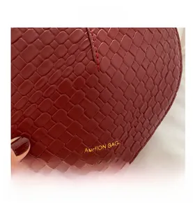 Close-up of red woven leather texture with gold Fashion Bags lettering and fine stitching