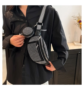Detail showing the black rhinestone waist bag with patterned strap and mini round coin pouch