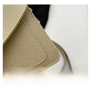 Detailed close-up showing precision stitching on khaki woven straw shoulder bag flap