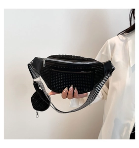 Detail of black rhinestone crossbody saddle bag with a wide striped shoulder strap