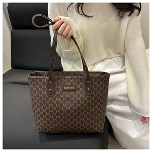 Detail of large tote bag with brown letter print and fashion logo for women