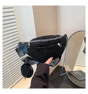 Detail of black rhinestone belt bag with chevron strap and small round charm pouch