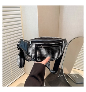 Close-up of black rhinestone fanny pack with wide woven strap and mini coin purse