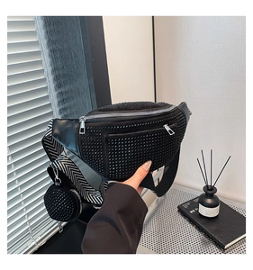 Detail of black rhinestone fanny pack with wide herringbone strap and round coin purse
